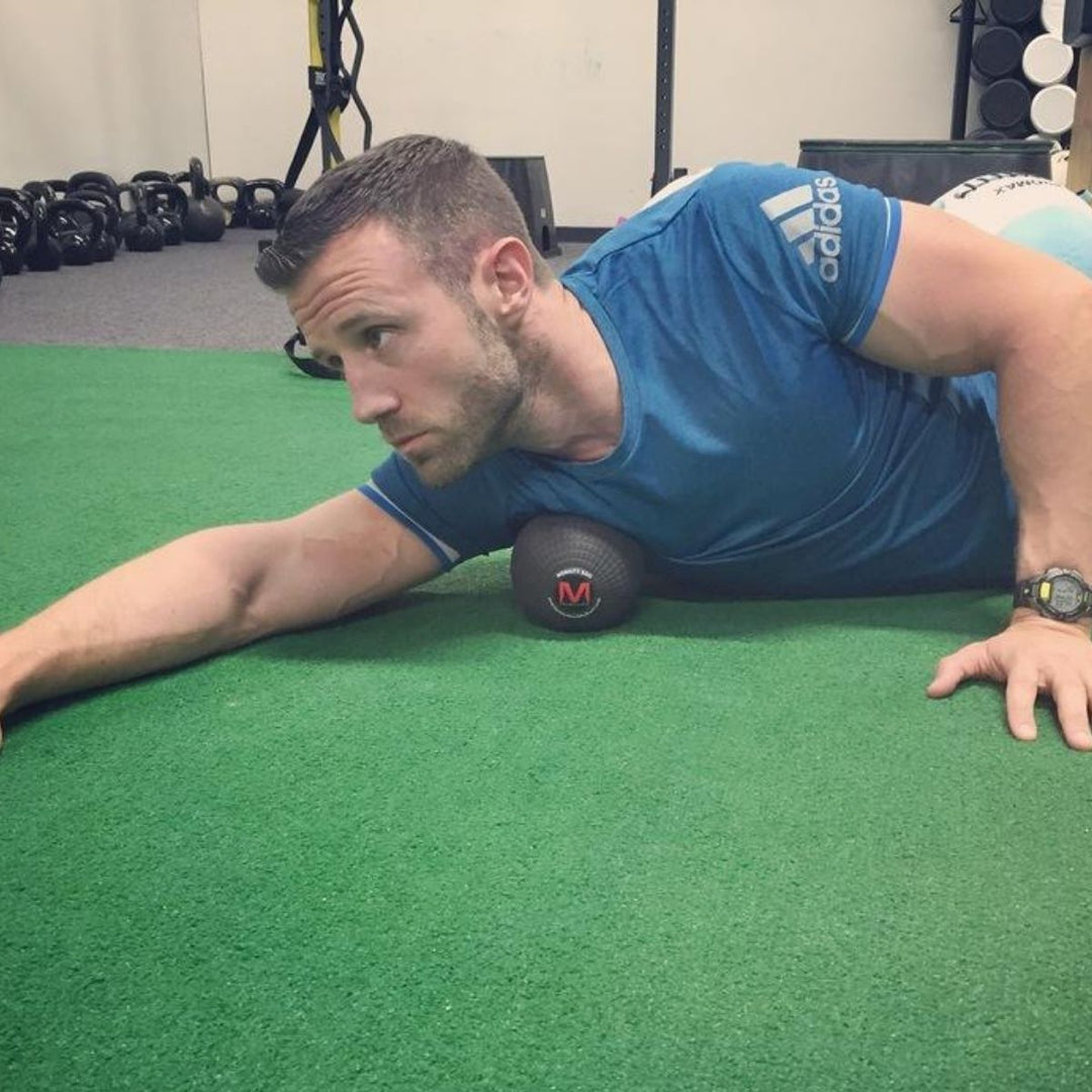 trigger point ball for deep tissue massage - chest - man using after workout for sore muscles